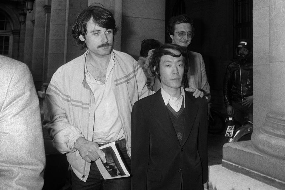 (FILES) This file photo taken on June 17, 1981 shows Japanese student Issei Sagawa (R), accused of murdering Dutch student Renée Hartevelt, being escorted by French plainclothes police as he leaves the Paris Police Prefecture Headquarters after questioning. - Sagawa died at the age of 73 on November 24, 2022 his friend and brother said in a statement on December 2. (Photo by DOMINIQUE FAGET / AFP)