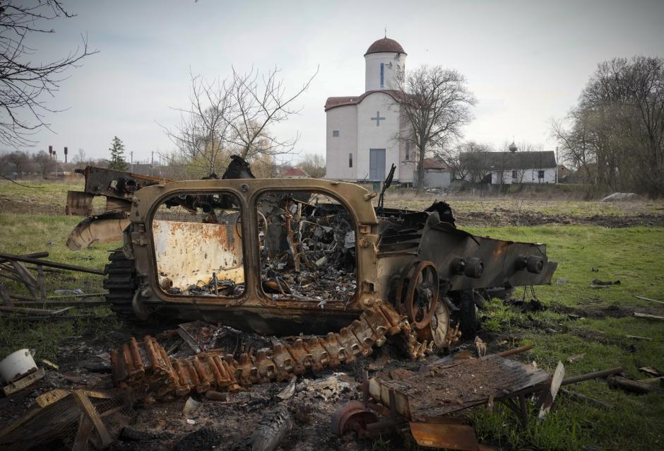 Fragments of a destroyed Russian military vehicle lie against the background of an Orthodox church in the village of Lypivka close to Kyiv, Ukraine, Monday, Apr. 11, 2022. Lypivka was occupied by the Russian troops at the beginning of the Russia-Ukraine war and freed recently by the Ukrainian army. (AP Photo/Efrem Lukatsky)