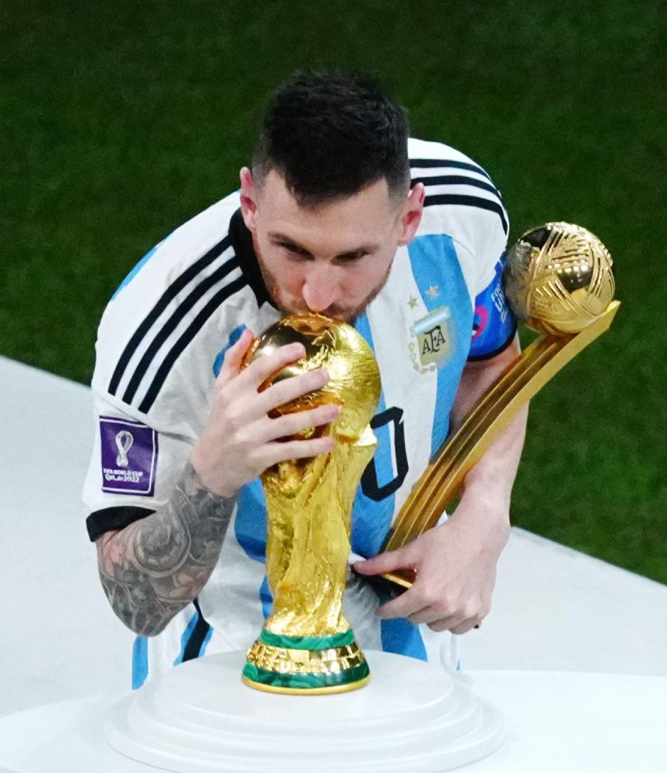 Argentina's Lionel Messi kisses the World Cup trophy after the World Cup final soccer match between Argentina and France at the Lusail Stadium in Lusail, Qatar, Sunday, Dec.18, 2022.