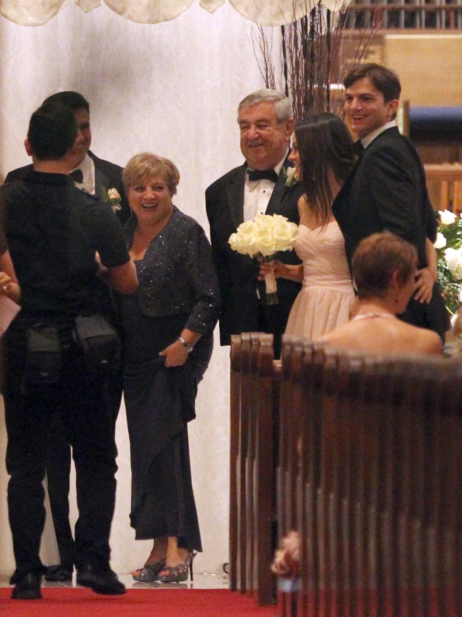 Actors Mila Kunis and Ashton Kutcher during wedding of Michael Kunis and Alexandra Blacker in St. Petersbrug, Florida on December 7, 2013