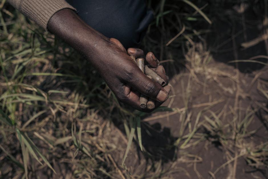 A man collects ammunition casings in Kishishe, eastern Democratic Republic of Congo, on April 5, 2023. - In late November 2022, according to UN reports, M23 (March 23 Movement) fighters massacred at least 170 civilians in Kishishe in a retaliation attack after being ambushed by a local armed group. For a year, the fighters of the M23 - "Movement of March 23", a predominantly Tutsi armed group - have been advancing in Congolese territory, taking control of main roads, seizing towns and border posts. The capture of Kishishe is also part of a fight by the M23 against the FDLR (Democratic Forces for the Liberation of Rwanda), a mainly Hutu armed group founded by former leaders of the genocide in Rwanda, exiled in the DRC. The latter have for years installed one of their bastions in the immediate vicinity of the village. (Photo by ALEXIS HUGUET / AFP)