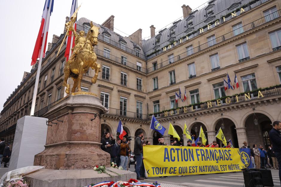 Members of the far-right French monarchist movement Action française take part in a rally next to the statue of Joan of Arc, in Paris, on May 14, 2023. French monarchist movement Action Francaise was cleared to hold a demonstration in Paris on May 14, 2023 after the courts reversed a police ban issued on orders from the interior ministry to curtail far-right protests. same time Sunday. Sunday's gathering will honour Joan of Arc, who led the French to a famous victory over the English in the 15th century. She is revered by many of France's far-right movements (Photo by Thomas SAMSON / AFP)