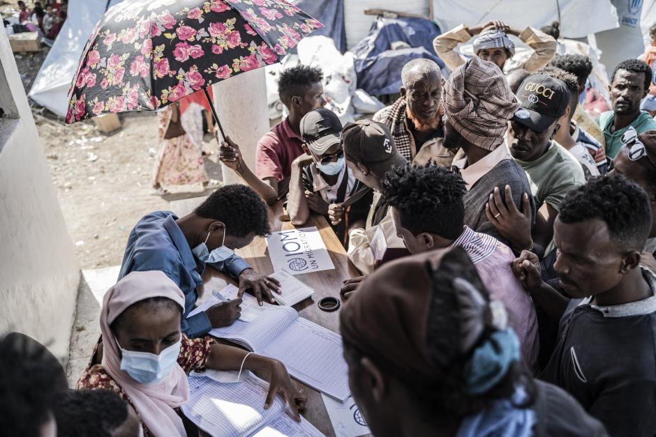 Workers register refugees who crossed from Sudan to Ethiopia at the IOM (International organization for Migration) office in Metema, on May 4, 2023. More than 15,000 people have fled Sudan via Metema since fighting broke out in Khartoum in mid-April, according to the UN's International Organization for Migration, with around a thousand arrivals registered per day on average. (Photo by Amanuel Sileshi / AFP)