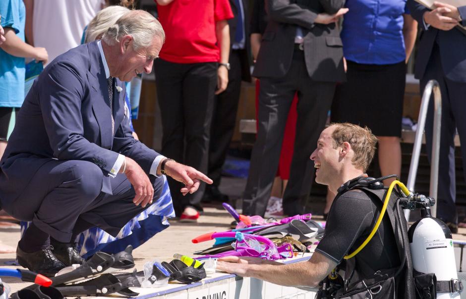 The Prince of Wales speaks with the Duke of Cambrige, as he scuba dives with British Sub-Aqua Club (BSAC) members at a swimming pool in London.