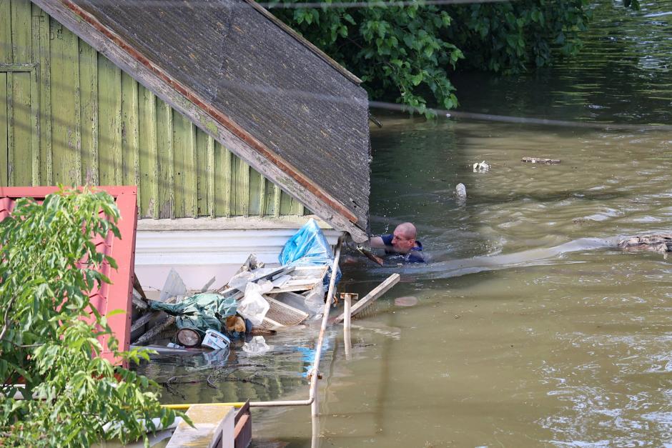 Un residente nada hasta su casa en una zona inundada en Jersón