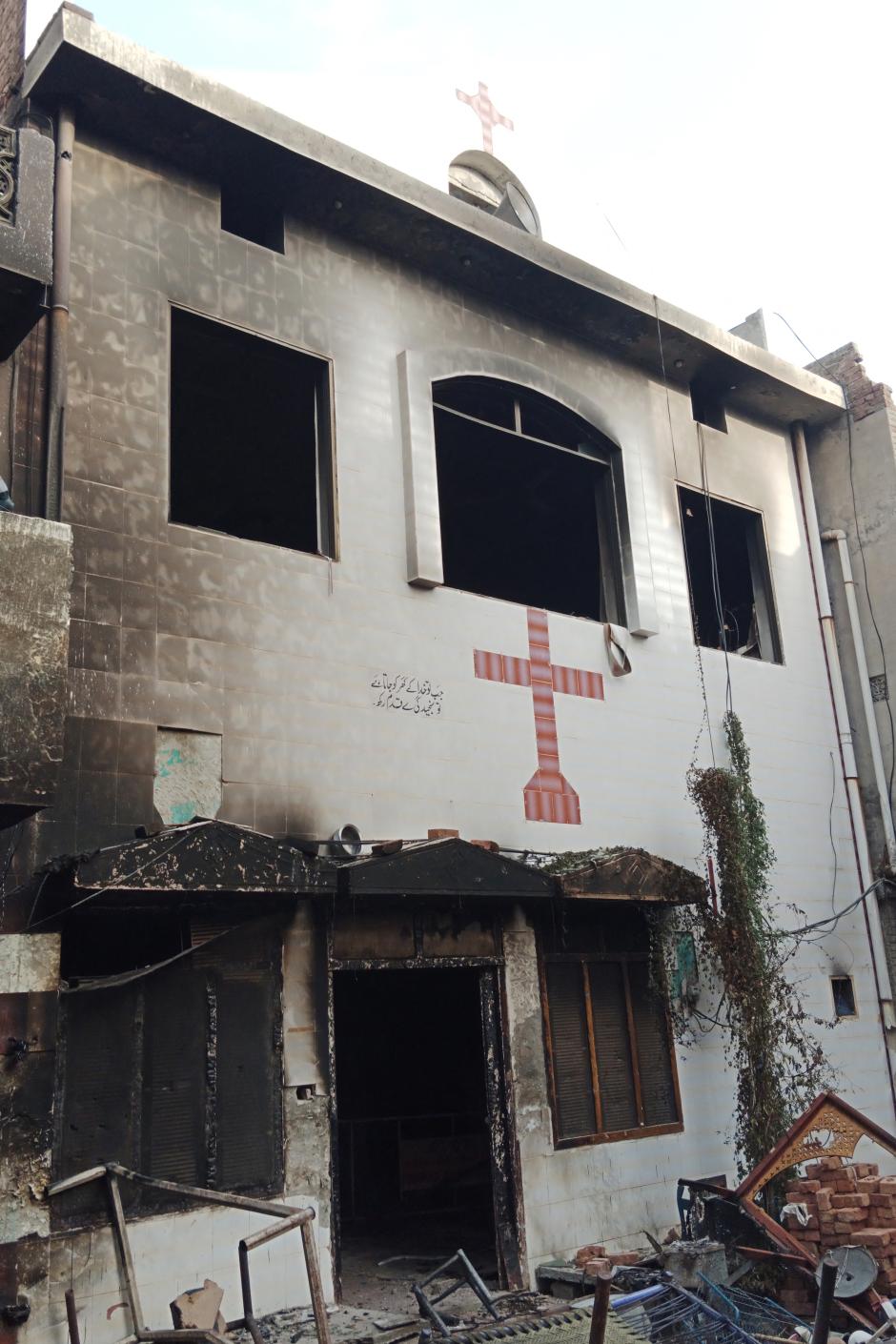 View of a burnt church on the outskirts of Faisalabad on August 16, 2023, following an attack by Muslim men after a Christian family was accused of blasphemy. Hundreds of Muslim men set fire to four churches and vandalised a cemetery during a rampage in eastern Pakistan on August 16, officials said, after a Christian family was accused of blasphemy. (Photo by Ghazanfar MAJID / AFP)