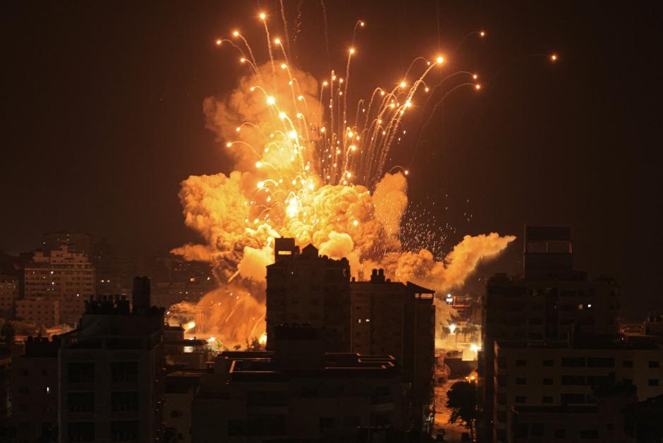 A missile explodes in Gaza City during an Israeli air strike on October 8, 2023. - srael, reeling from the deadliest attack on its territory in half a century, formally declared war on Hamas Sunday as the conflict's death toll surged close to 1,000 after the Palestinian militant group launched a massive surprise assault from Gaza. (Photo by MAHMUD HAMS / AFP)