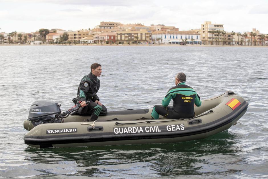 Dos agentes del Grupo Especial de Actividades Subacuáticas de la Guardia Civil buscan al joven desaparecido en el Mar Menor