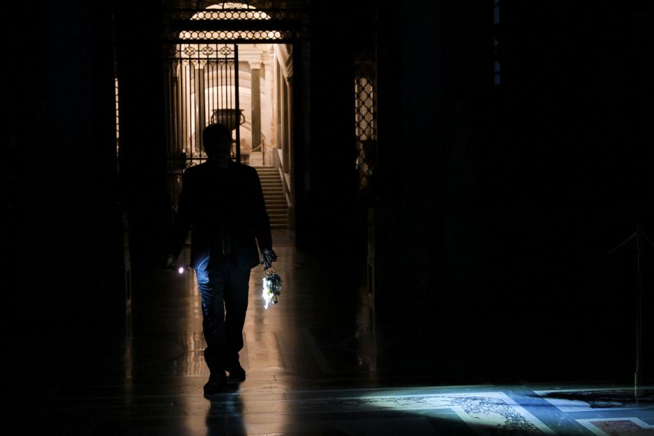 The cuppola of St.Peter's basilica is seen through the ring of a big mast of keys held by Gianni Crea, key keeper of the Vatican Museums, during a private visit of the museums by night, on February 13, 2024. (Photo by Tiziana FABI / AFP)