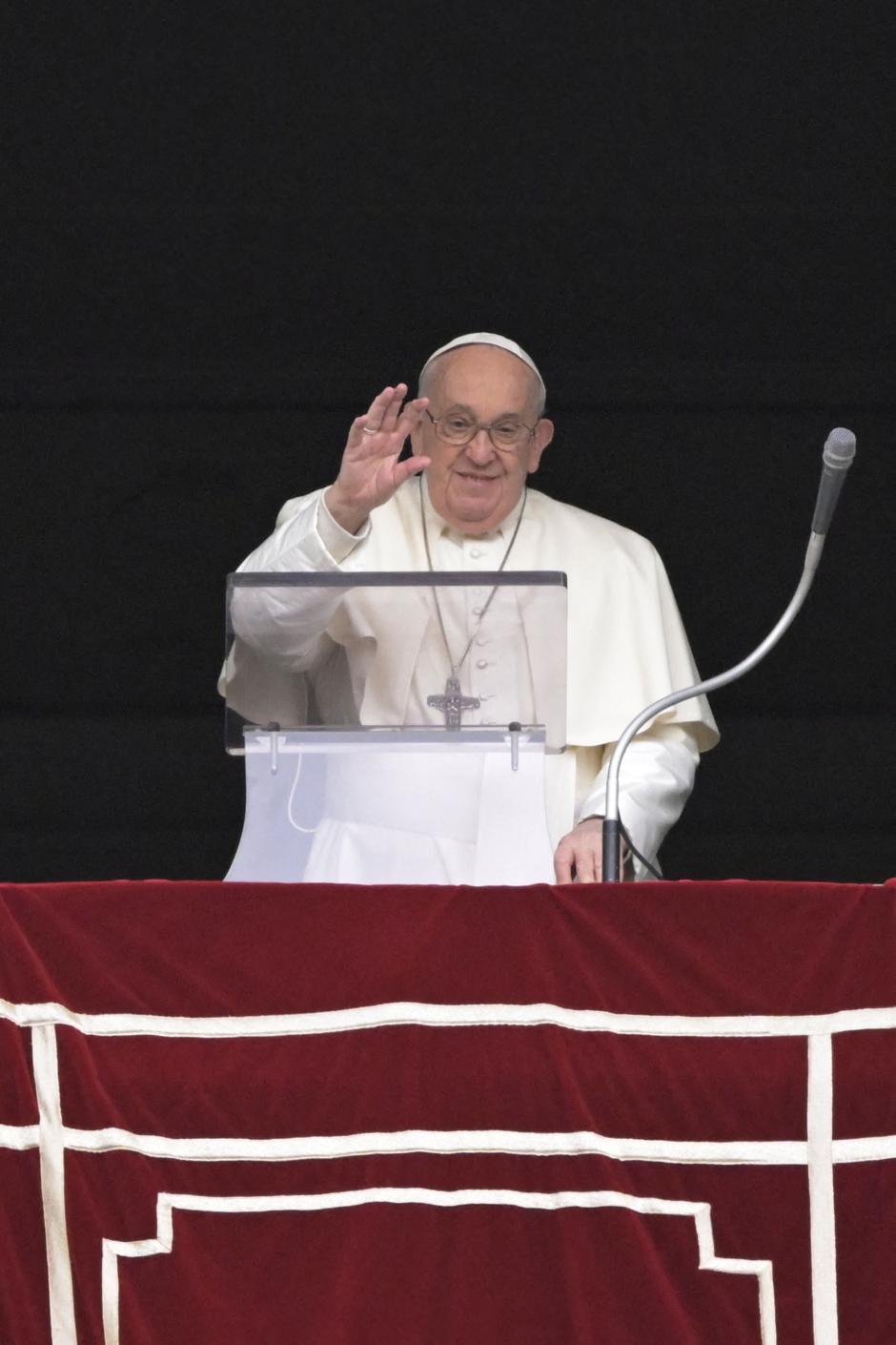 Pope Francis waves from the window of the apostolic palace overlooking St. Peter's square during the Regina Coeli prayer on April 1st, 2024 in The Vatican. (Photo by Tiziana FABI / AFP)