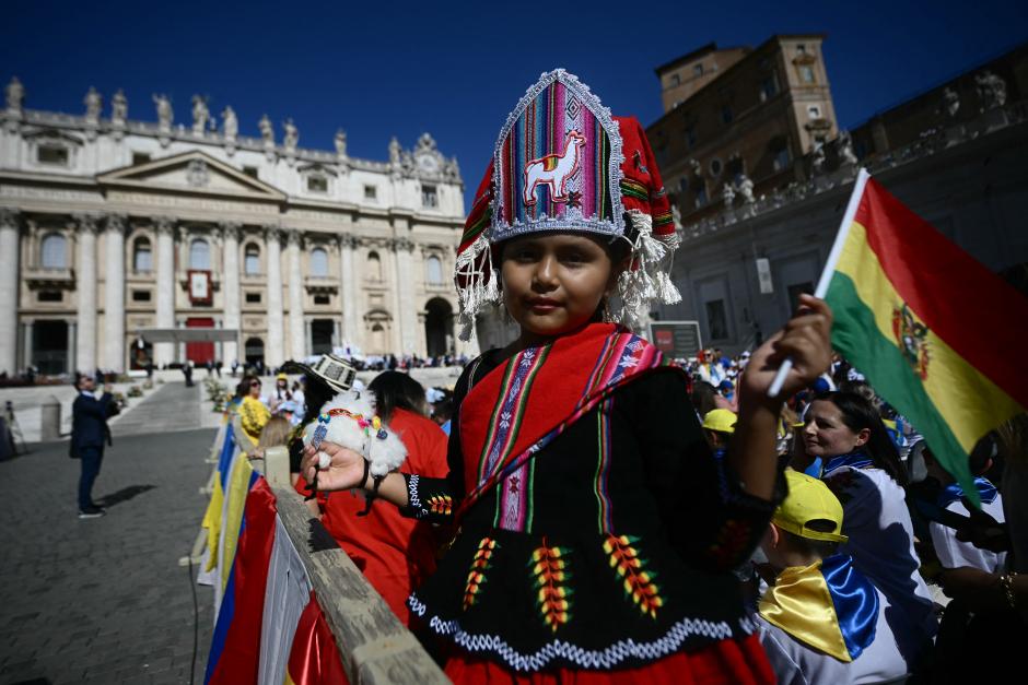 A Bolivian girl dressed in traditional costume waits for the arrival of the Pope ahead of a mass on World Children's Day at St Peter's Basilica in the Vatican on May 26, 2024. (Photo by Filippo MONTEFORTE / AFP)