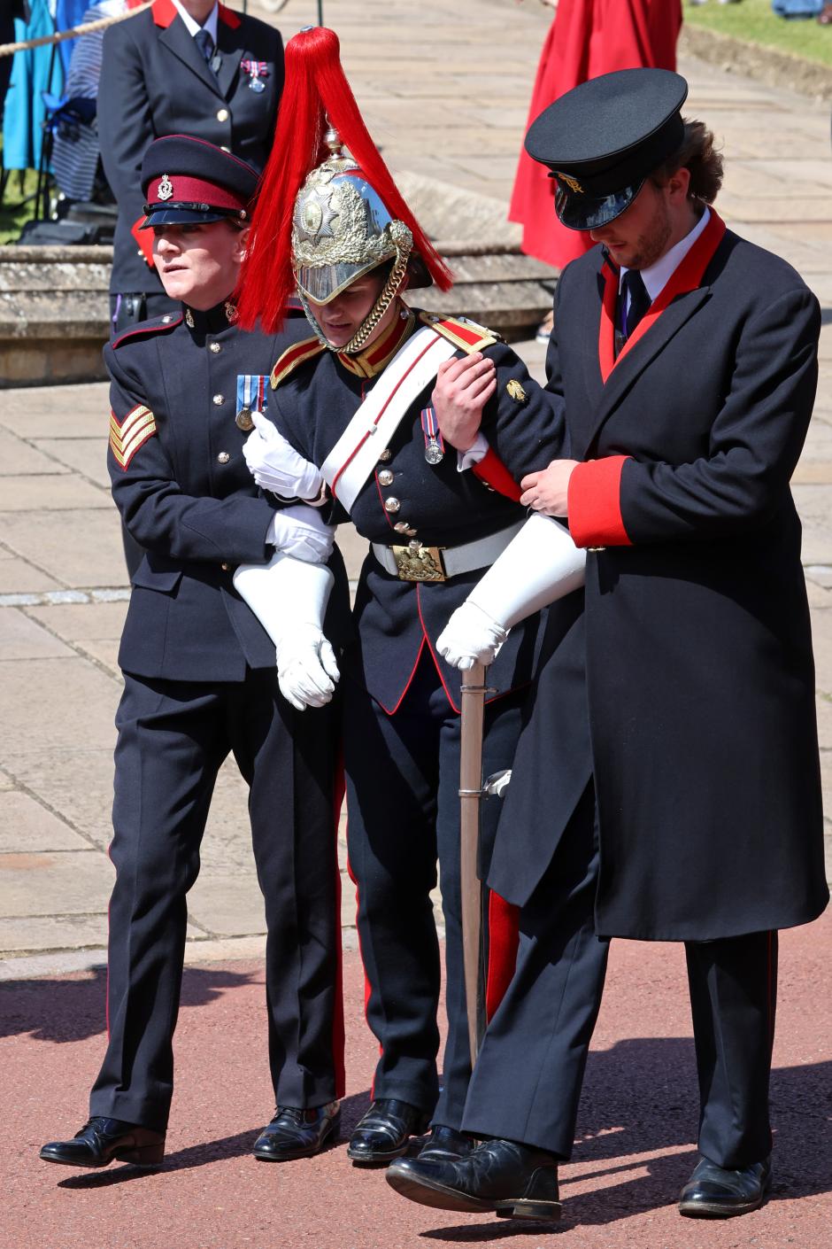 A soldier receives medical assistance during the annual Order of the Garter Service at St George's Chapel, Windsor Castle, Berkshire. Picture date: Monday June 17, 2024. *** Local Caption *** .