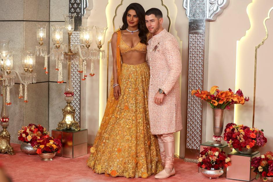 Mumbai (India), 12/07/2024.- Indian actor Priyanka Chopra (L) and her husband US singer Nick Jonas pose for photographs as they attend the wedding of Anant Ambani, son of Reliance Industries chairman Mukesh Ambani in Mumbai, India, 12 July 2024. Various global celebrities have arrived in Mumbai to attend the grand wedding of Anant Ambani and his bride Radhika Merchant. EFE/EPA/DIVYAKANT SOLANKI