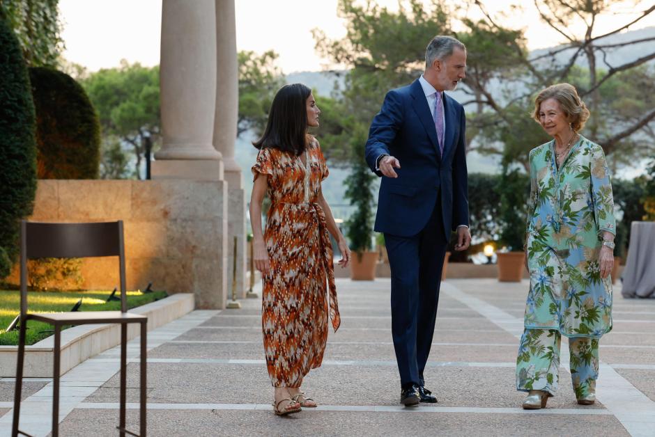 Los Reyes y Doña Sofía, junto a la silla alta preparada para Doña Letizia en los jardines de Marivent