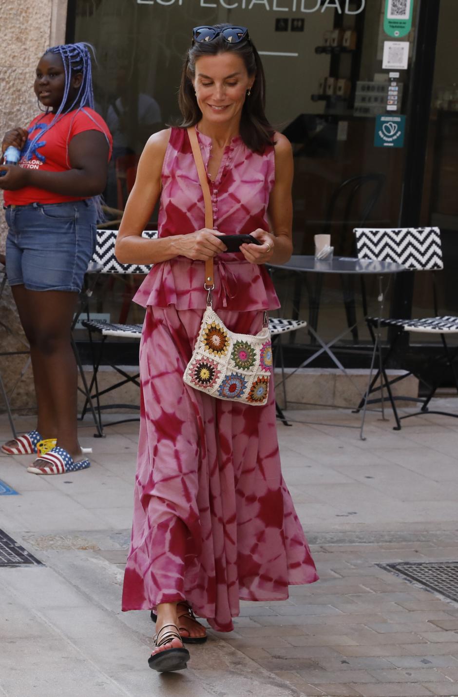 La Reina muy veraniega con su vestido rosa y bolso de crochet.