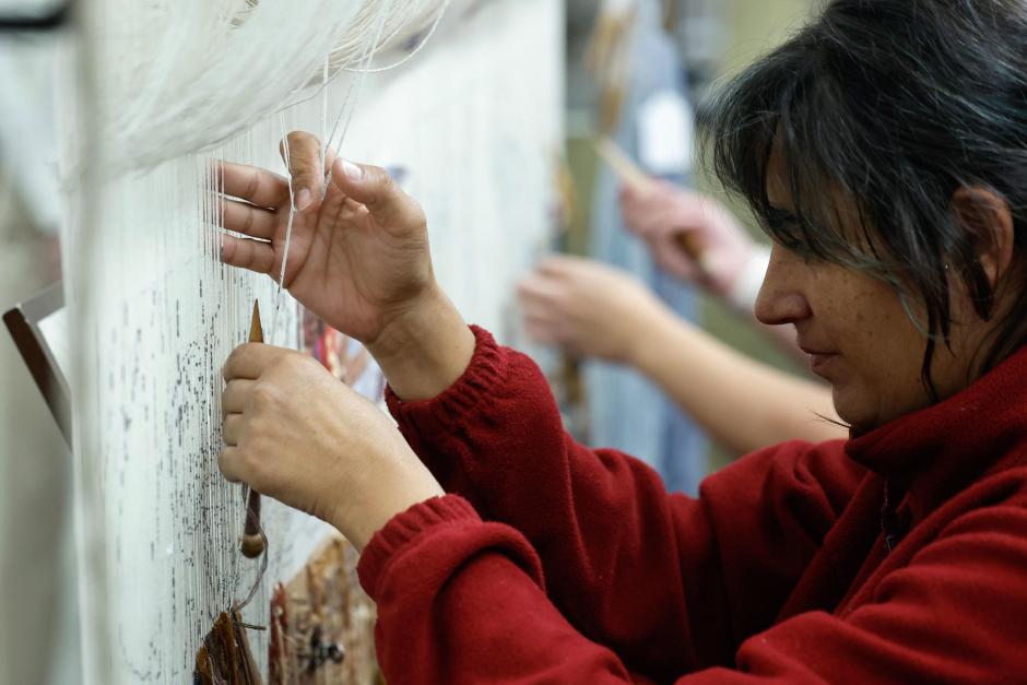 Las alfombras del Congreso son colocadas por unos operarios en una de las zonas de la Cámara Baja tras pasar varios meses en proceso de limpieza y reparación en la Real Fábrica de Tapices de Madrid por parte de las restauradoras de las mismas, que son mayoritariamente mujeres. EFE/ Chema Moya