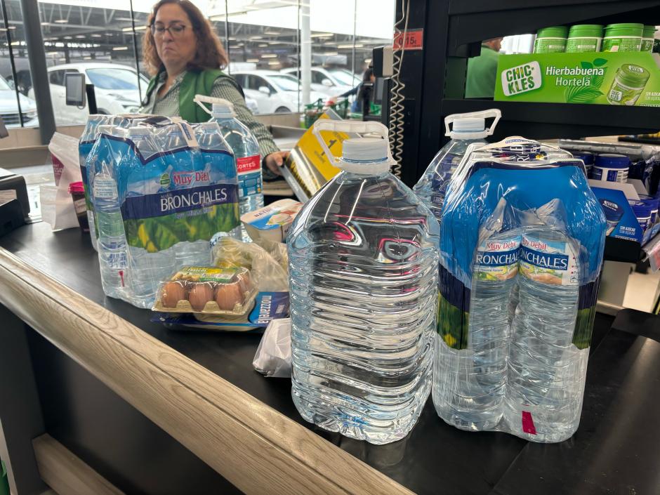 Caja de un supermercado en Valencia con varias botellas de agua