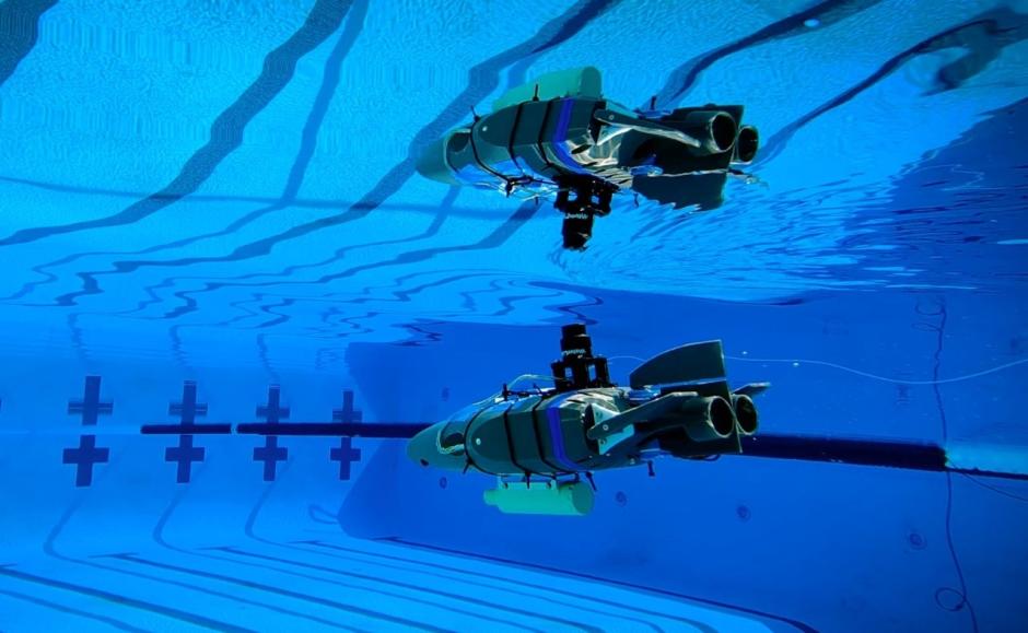 Un prototipo de robot diseñado para explorar los océanos subterráneos de las lunas heladas se refleja en la superficie del agua durante una prueba en una piscina en Caltech en septiembre