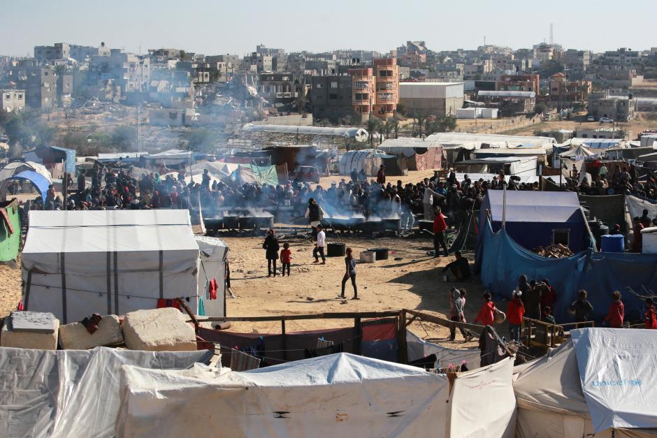 Un grupo de palestinos esperan una ración de comida en Khan Yunis, en el sur de la franja de Gaza