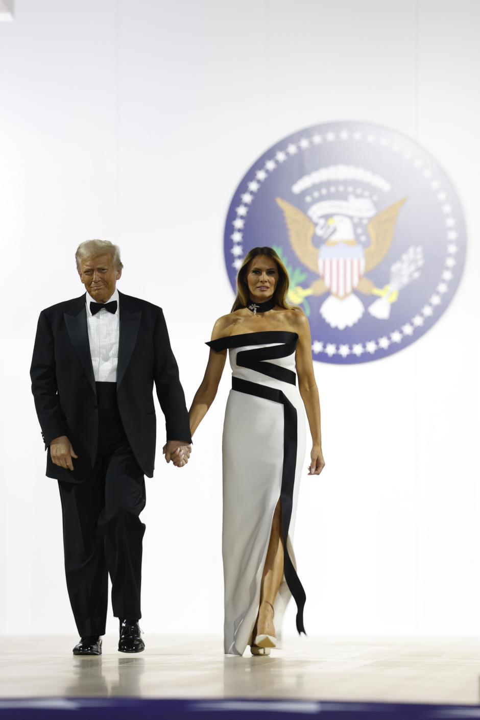 WASHINGTON, DC - JANUARY 20: President Donald Trump walks onstage with wife Melania at the Commander-in-Chief Ball on January 20, 2025 in Washington, DC. President Trump attends some of the inaugural balls after taking the oath as the 47th president. Credit: Anna Moneymaker / Pool via CNP