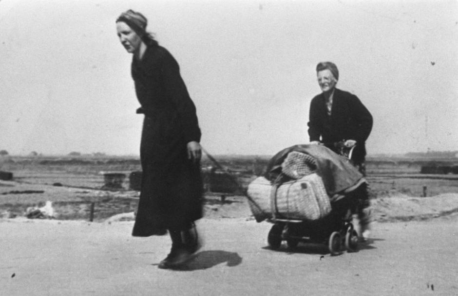 Dos mujeres holandesas transportan alimentos durante la hambruna