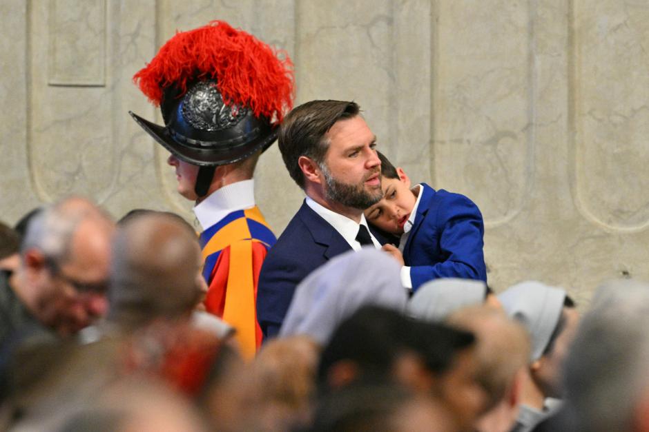 U.S. Vice President JD Vance holds his son as he arrives to attend the celebration of the Passion of the Lord on Good Friday as part of the Holy Week celebrations, at St Peter's Basilica in the Vatican on April 18, 2025. (Photo by Andreas SOLARO / AFP)