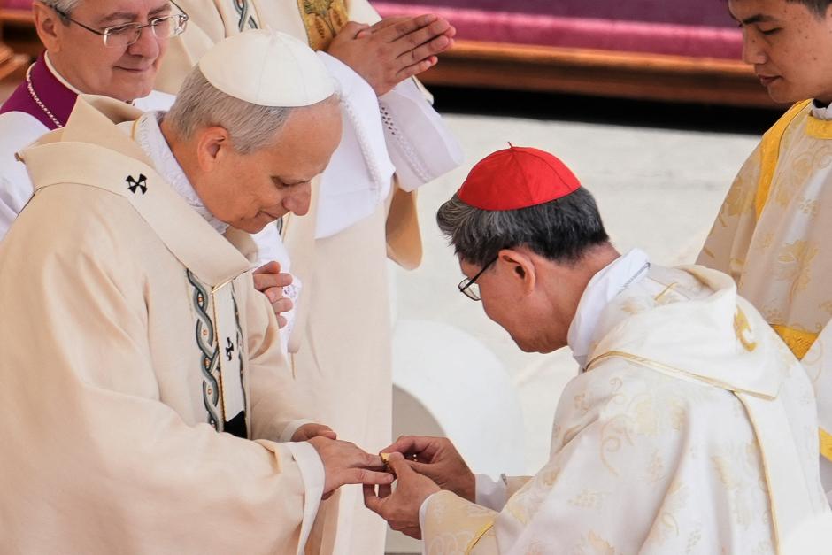 Filipino cardinal Luis Antonio Gokim Tagle puts the Fisherman's Ring on a finger of Pope Leo XIV during a mass for the beginning of his pontificate, in St Peter's square in The Vatican on May 18, 2025. (Photo by Jacquelyn Martin / POOL / AFP)