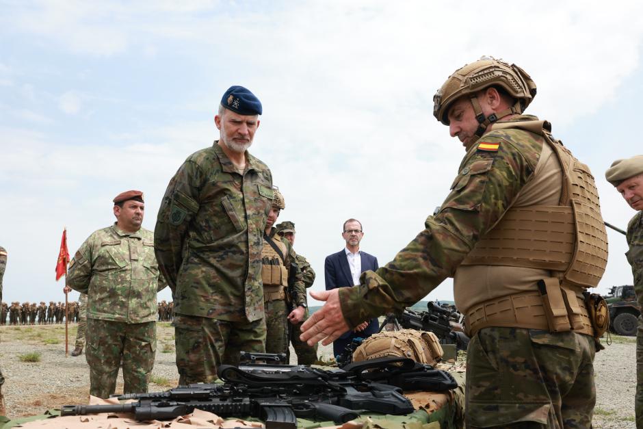 Un militar muestra armas al Rey en el campo de tiro North Cross de Rumanía