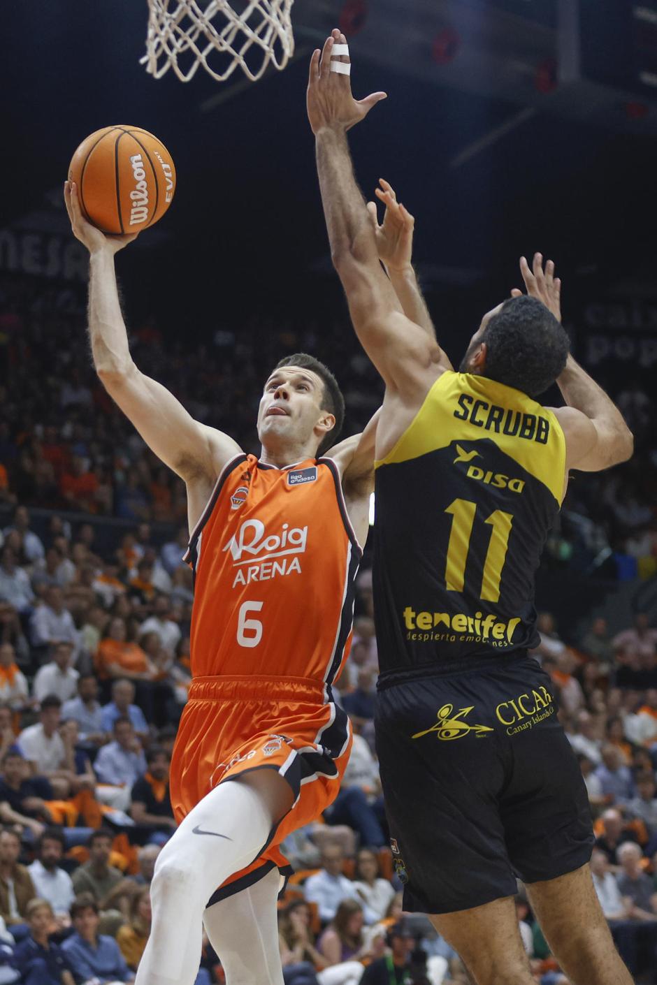 El jugador de Valencia Basket, Xabi López-Aróstegui (i), entra a canasta ante el jugador canadiense de La Laguna Tenerife, Thomas Scrubb