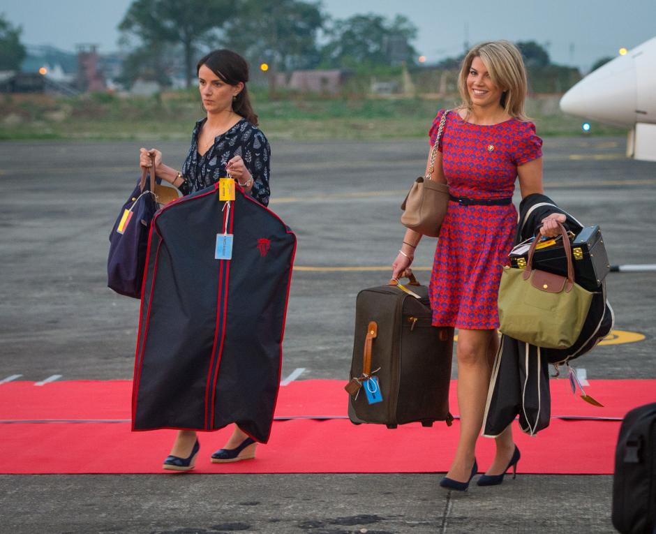 Assistant to the Duchess of Cambridge's Private Secretary Sophie Agnew (left) and the Duchess of Cambridge's PA and Stylist Natasha Archer carry items of luggage as they arrive at Tezpur Airport in Assam, India, on day three of the Royal visit to India and Bhutan.