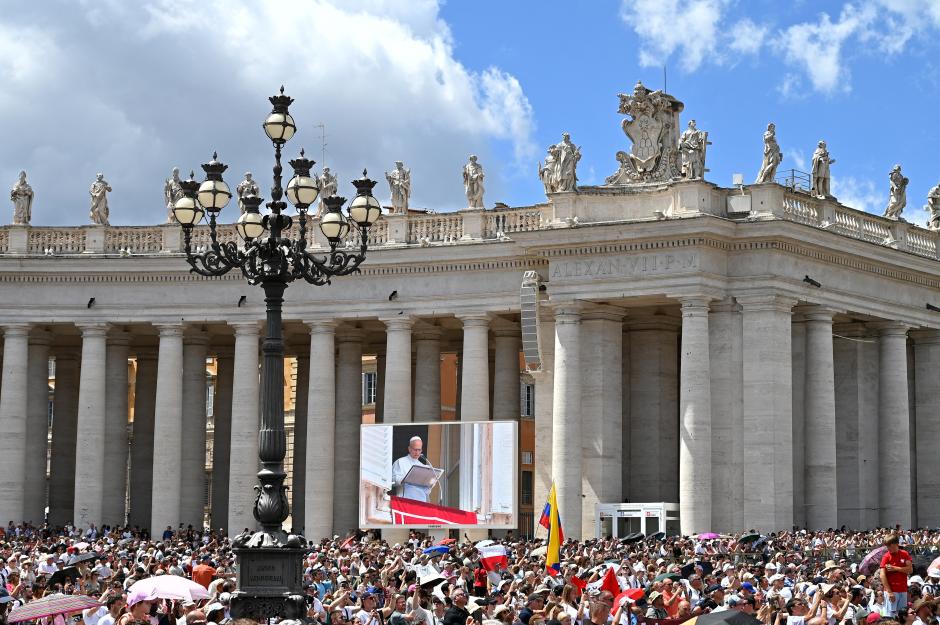 People pray as Pope Leo XIV addresses the crowd from the window of the Apostolic Palace overlooking St. Peter's square during his Angelus prayer at the Vatican on July 26, 2025. (Photo by Alberto PIZZOLI / AFP)