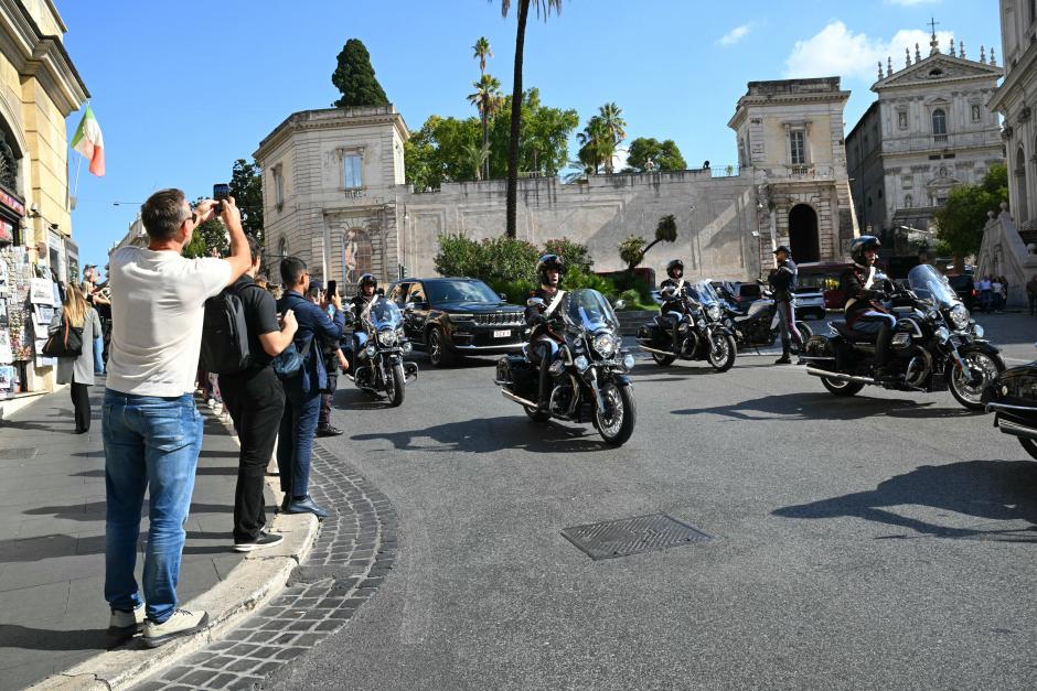 The car of Pope Leo XIV is escorted as he leaves the Quirinale Presidential Palace after a meeting with Italy's President Sergio Mattarella during an official visit, in Rome, on October 14, 2025. (Photo by Andreas SOLARO / AFP)