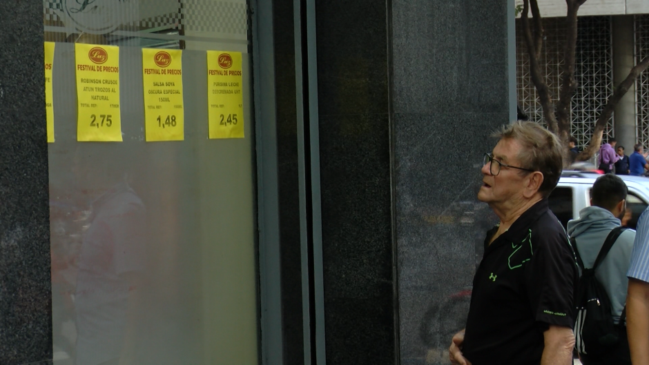 Una persona observa los precios de los productos en una tienda de Caracas