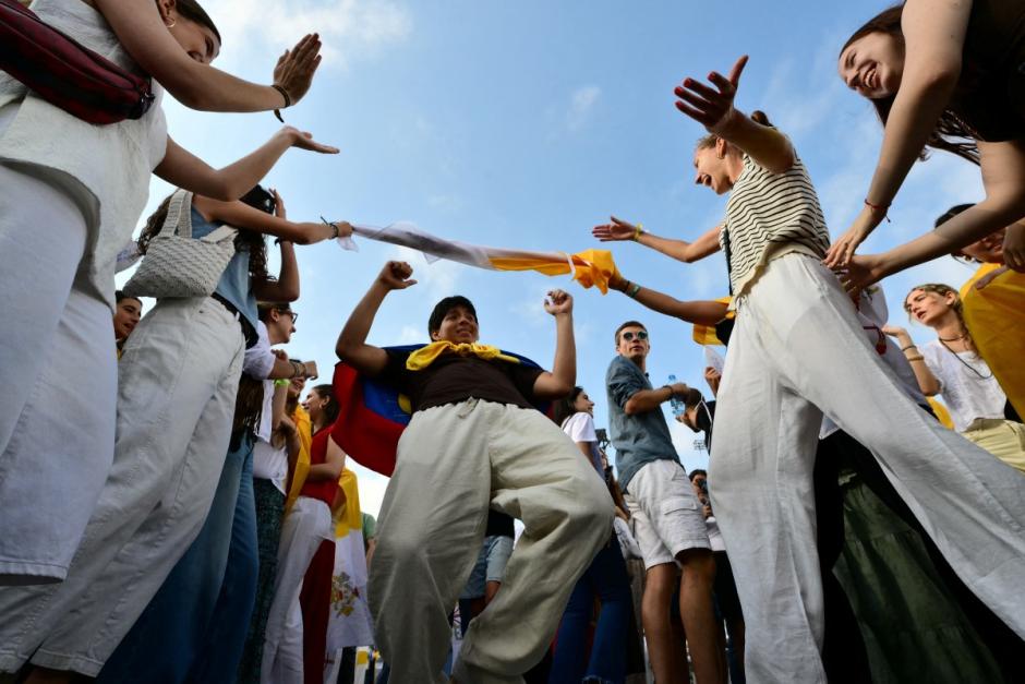 Attendees celebrate prior a prayer vigil at the Lluis Companys Olympic Stadium in Barcelona, on June 9, 2026. Pope Leo XIV is visiting Spain June 6-12 with stops in Madrid, Barcelona, and the Canary Islands, where he will meet with migrants and organisations dedicated to helping them. (Photo by Stefano RELLANDINI / AFP)