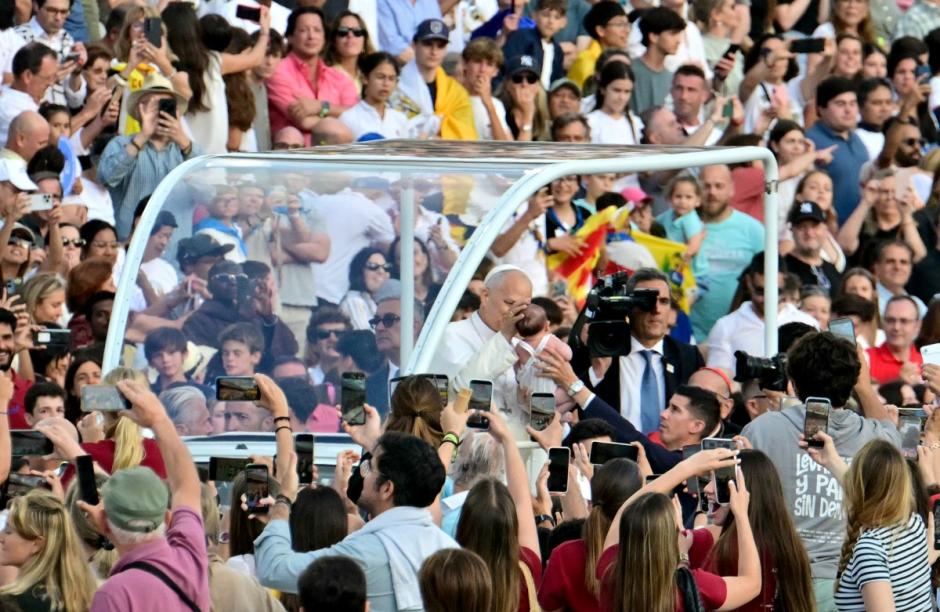 Pope Leo XIV blesses a child as he arrives to attend a prayer vigil at the Lluis Companys Olympic Stadium in Barcelona, on June 9, 2026. Pope Leo XIV is visiting Spain June 6-12 with stops in Madrid, Barcelona, and the Canary Islands, where he will meet with migrants and organisations dedicated to helping them. (Photo by Stefano RELLANDINI / AFP)