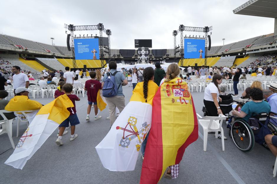 Los jóvenes esperando a la llegada del Papa en el Estadio Olímpico de Barcelona, portando las banderas del Vaticano y de España