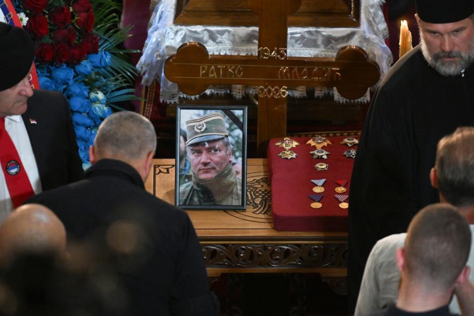 Mourners stand next to the coffin of late Bosnian Serb military leader Ratko Mladic while taking part in a public memorial on the day of his funeral ceremony at St Lukas church in Belgrade, on September 7, 2026. Mladic, 84, died last week after suffering several strokes while serving a life sentence in The Hague for war crimes committed during the 1990s war in Bosnia. (Photo by OLIVER BUNIC / AFP)